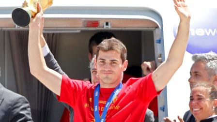 Spains captain Iker Casillas raises the World Cup trophy as he leaves the aircraft that brought the Spanish team back from South Africa, at Madrids Barajas airport, Monday, July 12, 2010. Spain won the World Cup after defeating the Netherlands 1-0 on Sunday. (AP Photo/Armando Franca)