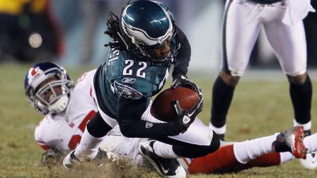 Philadelphia Eagles cornerback Asante Samuel pulls in an interception on a pass intended for New York Giants wide receiver Derek Hagan, rear, during the second half of an NFL football game in Philadelphia, Sunday, Nov. 21, 2010. The Eagles won 27 -17.