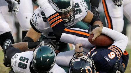 Philadelphia Eagles defensive end Trent Cole (58) sacks Chicago Bears quarterback Jay Cutler (6) in the first half of an NFL football game in Chicago, Sunday, Nov. 28, 2010. Helping on the play is Eagles defensive end Daniel Teo-Nesheim (52). (AP Photo/Kiichiro Sato)