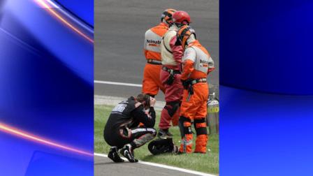 IndyCar driver JR Hildebrand reacts next to track safety personnel after he crashed on the final lap of the Indianapolis 500 auto race at the Indianapolis Motor Speedway in Indianapolis, Sunday, May 29, 2011. Dan Wheldon, of England, won the race. (AP Photo/Paul Sancya)