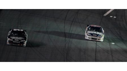 Kevin Harvick, left, passes Dale Earnhardt Jr. to win the race on the final lap as Earnhardt runs out of gas coming out of Turn 4 during the NASCAR Sprint Cup Series Coca-Cola 600 auto race in Concord, N.C., Sunday, May 29, 2011. (AP Photo/Gerry Broome)