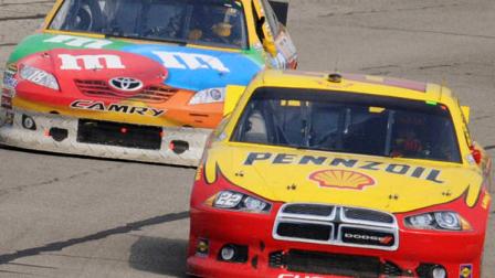 Kurt Busch, right, and Kyle Busch enter Turn 2 during the NASCAR Sprint Cup Series auto race, Sunday, June 12, 2011, in Long Pond, Pa. (AP Photo/Derick Hamilton)