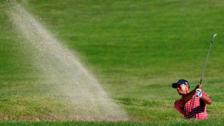Tiger Woods hits from a fairway bunker on the second hole during the final round of the Frys.com Open golf tournament, Sunday, Oct. 9, 2011, in San Martin, Calif. (AP Photo/Marcio Jose Sanchez)