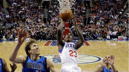 Philadelphia 76ers point guard Lou Williams (23) shoots between Dallas Mavericks power forward Dirk Nowitzki (41), from Germany, and point guard Jason Kidd (2) in the second half of an NBA basketball game Friday, Feb. 17, 2012, in Philadelphia. The Mavericks won 82-75. (AP Photo/Alex Brandon)