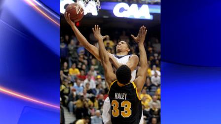 Drexel guard Damion Lee (14) goes up for a layup over Virginia Commonwealth center D.J. Haley (33) during the first half of the Colonial Athletic Association Championship NCAA college basketball game at the Coliseum in Richmond, Va., Monday, March 5, 2012. (AP Photo/Steve Helber)