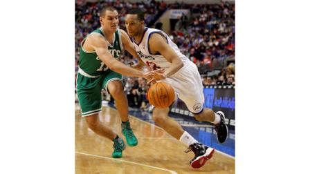 Boston Celtics forward Sasha Pavlovic (11), from Montenegro, reaches in as Philadelphia 76ers guard Evan Turner (12) drives with the ball in the second half of an NBA basketball game Wednesday, March 7, 2012 in Philadelphia. Turner had 26 points and he 76ers won 103-71. (AP Photo/Alex Brandon)