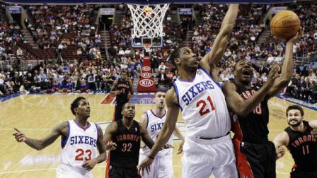 Philadelphia 76ers forward Thaddeus Young (21) defends as Toronto Raptors guard Ben Uzoh (18) shoots in the first half of an NBA basketball game, Wednesday, April 4, 2012, in Philadelphia. The Raptors won 99-78. (AP Photo/Alex Brandon)