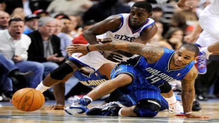 Philadelphia 76ers Jrue Holiday (11) and Orlando Magics Jameer Nelson (14) chase down a loose ball in the second half of an NBA basketball game, Saturday, April 7, 2012, in Philadelphia. The Magic won 88-82. (AP Photo/Michael Perez)