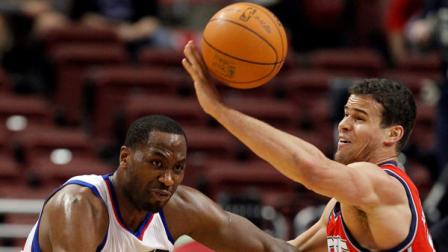 Philadelphia 76ers forward Elton Brand, left, has the ball knocked away by New Jersey Nets forward Kris Humphries , right, in the first half of an NBA basketball game on Friday, April 13, 2012, in Philadelphia. The Nets won 95-89. (AP Photo/Alex Brandon)