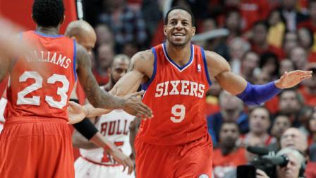 Philadelphia 76ers forward Andre Iguodala (9) smiles as he celebrates with guard Louis Williams (23) after his dunk against the Chicago Bulls during the third quarter of Game 2 in an NBA basketball first-round playoff series, in Chicago on Tuesday, May 1, 2012. (AP Photo/Nam Y. Huh)