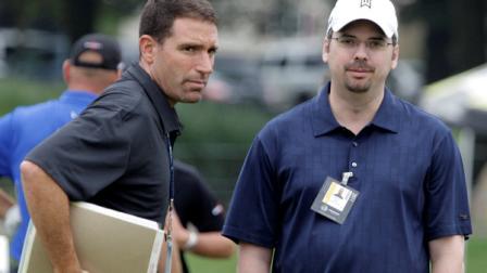 Tiger Woods agent Mark Steinberg, left and caddie Bryon Bell are seen on the driving range during practice for the Bridgestone Invitational golf tournament at Firestone Country Club in Akron, Ohio on Wednesday, Aug. 3, 2011. (AP Photo/Amy Sancetta)