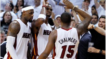 Miami Heats Chris Bosh, center, Mario Chalmers, right, and LeBron James congratulate each other during the second half of Game 7 of the NBA basketball playoffs Eastern Conference finals against the Boston Celtics, Saturday, June 9, 2012, in Miami. The Heat defeated the Celtics 101-88. (AP Photo/Lynne Sladky)