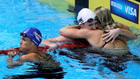 Dara Torres, left, looks at the results after swimming in the womens 50-meter freestyle final at the U.S. Olympic swimming trials as Kara Lynn Joyce and Jessica Hardy, right, celebrate, Monday, July 2, 2012, in Omaha, Neb. (AP Photo/Nati Harnik)