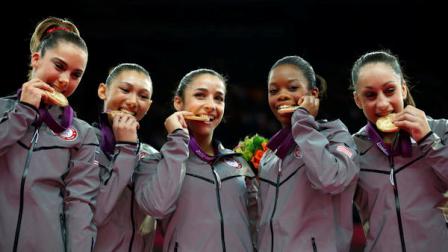 U.S. gymnast McKayla Maroney, Kyla Ross, Alexandra Raisman, Gabrielle Douglas and Jordyn Wieber bite their gold medals at the Artistic Gymnastics womens team final at the 2012 Summer Olympics, Tuesday, July 31, 2012, in London. (AP Photo/Matt Dunham)