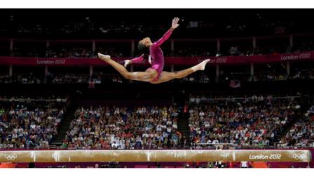 U.S. gymnast Gabrielle Douglas performs on the balance beam during the artistic gymnastics womens individual all-around competition at the 2012 Summer Olympics, Thursday, Aug. 2, 2012, in London. (AP Photo/Gregory Bull)