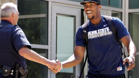 Penn State University football wide receiver Justin Brown, right, leaves the Lasch Football building after a team meetings explaining the ramifications of the NCAA sanctions against the Penn State University football program in State College, Pa., Monday, July 23, 2012. (AP Photo/Gene J. Puskar)