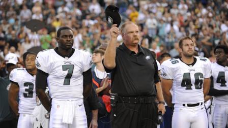 Philadelphia Eagles Michael Vick and coach Andy Reid stand on the sideline during a moment of silence for Reids son Garrett, who died Sunday, before an NFL preseason football game against the Pittsburgh Steelers, Thursday, Aug. 9, 2012, in Philadelphia. (AP Photo/Michael Perez)