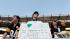 Jim Buto holds a sign honoring Garrett Reid as...