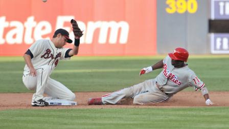 Philadelphia Phillies Jimmy Rollins (11) slides into second base safe on a steal as Atlanta Braves Paul Janish, left, loses control of the ball during the ninth inning, of a baseball game Saturday, Sept. 1, 2012, at Turner Field in Atlanta. The Phillies won 5-1. (AP Photo/Gregory Smith)