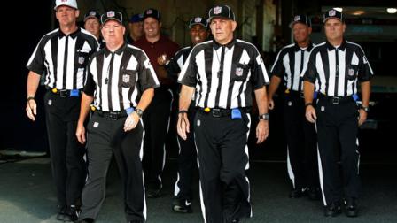 FILE - In this Aug. 9, 2012, file photo, officials walk towards the field for an NFL football game between the Buffalo Bills and the Washington Redskins in Orchard Park, N.Y. The NFL and referees union reached a tentative agreement on Wednesday, Sept. 26, to end a three-month lockout that triggered a wave of frustration and anger over replacement officials and threatened to disrupt the rest of the season. (AP Photo/Bill Wippert, File)