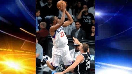 Philadelphia 76ers Thaddeus Young (21) leaps over Brooklyn Nets Mirza Teletovic (33) during the first half on an NBA preseason basketball game Friday, Oct. 19, 2012, in New York. (AP Photo/Kathy Kmonicek)