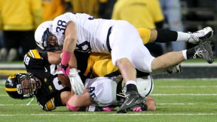 Penn State linebacker Glenn Carson (40) and Penn State linebacker Ben Kline (38) tackle Iowa tight end C.J. Fiedorowicz (86) during the second half of an NCAA college football game at Kinnick Stadiumin Iowa City, Iowa, Saturday, Oct. 20, 2012. Penn State won the game 38-14.