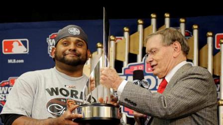 Commissioner Bud Selig hands San Francisco Giants Pablo Sandoval his MVP trophy after Game 4 of baseballs World Series against the Detroit Tigers Sunday, Oct. 28, 2012, in Detroit. The Giants won 4-3 to win the series. (AP Photo/Matt Slocum, Pool )