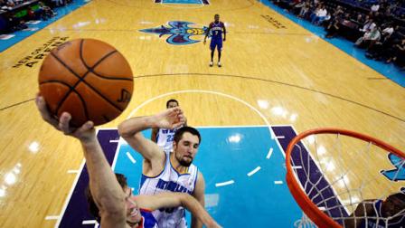 Philadelphia 76ers center Spencer Hawes drives to the basket in front of New Orleans Hornets power forward Ryan Anderson in the second half of an NBA basketball game in New Orleans, Wednesday, Nov. 7, 2012. The 76ers won 77-62. (AP Photo/Gerald Herbert)