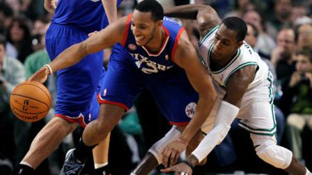 Philadelphia 76ers Evan Turner (12) and Boston Celtics Rajon Rondo, right, scramble for a loose ball in the second quarter of an NBA basketball game in Boston, Friday, Nov. 9, 2012. (AP Photo/Michael Dwyer)
