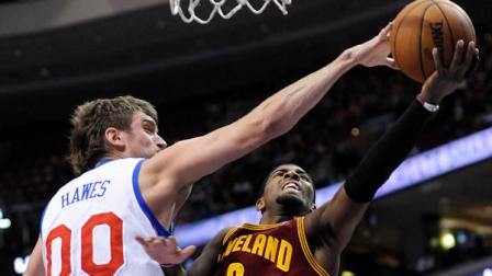 Philadelphia 76ers Spencer Hawes (00) blocks a shot from Cleveland Cavaliers Kyrie Irving (2) during the first half of an NBA basketball game on Sunday, Nov. 18, 2012, in Philadelphia. (AP Photo/Michael Perez)