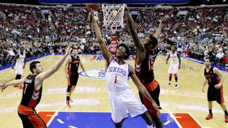 Philadelphia 76ers Nick Young (1) drives to the basket between Toronto Raptors Amir Johnson (15) and Andrea Bargnani (7), of Italy, in the second half of an NBA basketball game, Tuesday, Nov. 20, 2012, in Philadelphia. Philadelphia won 106-98. (AP Photo/Matt Slocum)