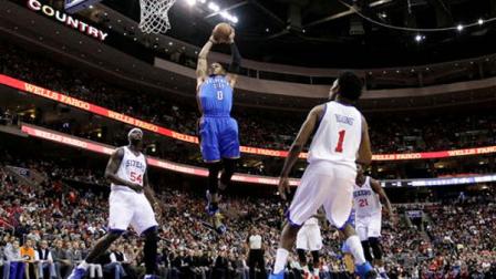 Oklahoma City Thunders Russell Westbrook (0) goes up for a dunk as Philadelphia 76ers Kwame Brown (54) and Nick Young (1) look on during the first half of an NBA basketball game, Saturday, Nov. 24, 2012, in Philadelphia. (AP Photo/Matt Slocum)