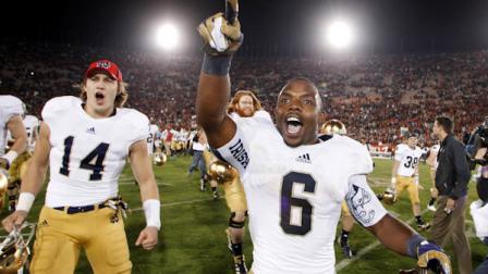 Notre Dame running back Theo Riddick, right, and wide receiver Luke Massa, left, celebrate after Notre Dame defeated Southern California 22-13 in an NCAA college football game, Saturday, Nov. 24, 2012, in Los Angeles. (AP Photo/Danny Moloshok)