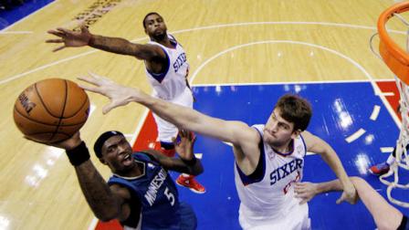 Minnesota Timberwolves Josh Howard (5) shoots as Philadelphia 76ers Spencer Hawes, right, and Dorell Wright defend in the first half of an NBA basketball game, Tuesday, Dec. 4, 2012, in Philadelphia. (AP Photo/Matt Slocum)