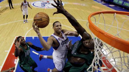 Philadelphia 76ers Evan Turner, center, goes up for a shot between Boston Celtics Kevin Garnett, right, and Jeff Green in overtime of an NBA basketball game, Friday, Dec. 7, 2012, in Philadelphia. The 76ers won 95-94 in overtime. (AP Photo/Matt Slocum)