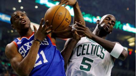 Philadelphia 76ers Thaddeus Young (21) and Boston Celtics Kevin Garnett (5) vie for a rebound in the first quarter of an NBA basketball game in Boston, Saturday, Dec. 8, 2012. (AP Photo/Michael Dwyer)