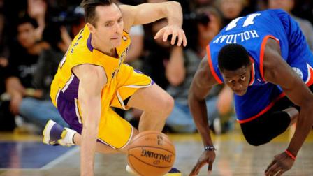 Los Angeles Lakers guard Steve Nash, left, and Philadelphia 76ers guard Jrue Holiday, right, fight for a loose ball in the first half of an NBA basketball game, Tuesday, Jan. 1, 2013, in Los Angeles. (AP Photo/Gus Ruelas)