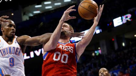 Oklahoma City Thunder forward Serge Ibaka (9) reaches for the ball as Philadelphia 76ers forward Spencer Hawes (00) shoots in the second quarter of an NBA basketball game in Oklahoma City, Friday, Jan. 4, 2013. Oklahoma City won 109-85. (AP Photo/Sue Ogrocki)