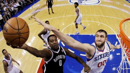 Brooklyn Nets Andray Blatche (0) shoots against Philadelphia 76ers Spencer Hawes (00) in the first half of an NBA basketball game, Tuesday, Jan. 8, 2013, in Philadelphia. (AP Photo/Matt Slocum)