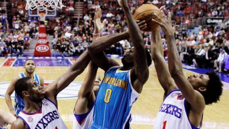 New Orleans Hornets Al-Farouq Aminu (0) tries to get a shot off as Philadelphia 76ers Thaddeus Young (21), Evan Turner and Nick Young (1) defend during the second half of an NBA basketball game, Tuesday, Jan. 15, 2013, in Philadelphia. New Orleans won 111-99. (AP Photo/Matt Slocum)
