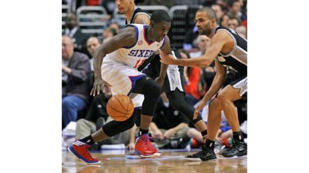 Philadelphia 76ers Jrue Holiday (11) drives against San Antonio Spurs Tony Parker during the first half of an NBA basketball game Monday Jan. 21, 2013, in Philadelphia. (AP Photo H. Rumph Jr)