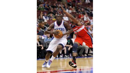 Washington Wizards John Wall (2) defends as Philadelphia 76ers Jrue Holiday drives into the lane during the first half of an NBA basketball game Wednesday, Jan. 30, 2013, in Philadelphia. (AP Photo H. Rumph Jr)