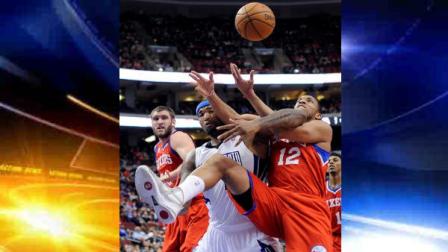 Philadelphia 76ers Evan Turner (12) pulls in a rebound over Sacramento Kings DeMarcus Cousins (15) during the first half of an NBA basketball game, Friday, Feb. 1, 2013, in Philadelphia. (AP Photo/Michael Perez)