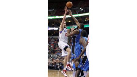 Philadelphia 76ers Spencer Hawes (00) shoots over Orlando Magics Kyle OQuinn during the second half of an NBA basketball game Monday, Feb. 4, 2013, in Philadelphia. The 76ers won 78-61. (AP Photo H. Rumph Jr)