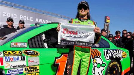 Danica Patrick displays the flag after winning the pole during qualifying for the NASCAR Daytona 500 Sprint Cup Series auto race at Daytona International Speedway, Sunday, Feb. 17, 2013, in Daytona Beach, Fla. Patrick won the pole, becoming the first woman to secure the top spot for any Sprint Cup race. (AP Photo/Terry Renna)