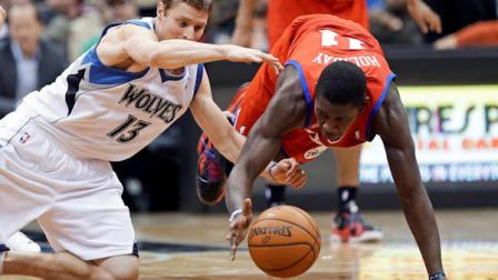Minnesota Timberwolves Luke Ridnour, left, and Philadelphia 76ers Jrue Holiday scramble for the loose ball in the second half of an NBA basketball game Wednesday, Feb. 20, 2013, in Minneapolis. The Timberwolves won 94-87. Holiday scored 16 points. (AP Photo/Jim Mone)