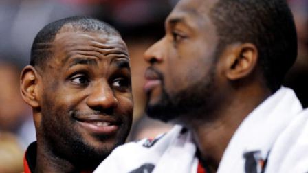 Miami Heats LeBron James, left, and Miami Heats Dwyane Wade (3) watch the game from the bench in the final minutes of the second half of an NBA basketball game against the Philadelphia 76ers, Saturday, Feb. 23, 2013, in Philadelphia. The Heat won, 114-90. (AP Photo/Michael Perez)