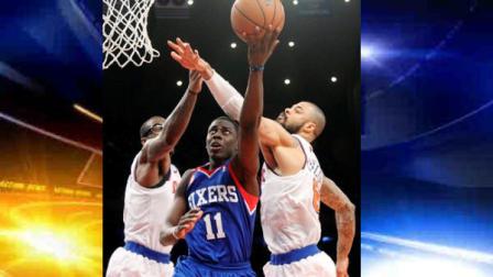 Philadelphia 76ers Jrue Holiday (11) shoots against New York Knicks Amare Stoudemire, left, and Tyson Chandler during the second half of their NBA basketball game, Sunday, Feb. 24, 2013, at Madison Square Garden in New York. The Knicks won 99-93. (AP Photo/Mary Altaffer)