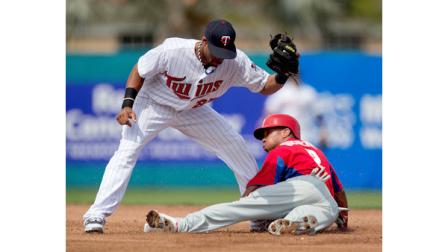 Philadelphia Phillies Ben Revere, right, beats the tag by Minnesota Twins Pedro Florimon to steal second base in the first inning of an exhibition spring training baseball game, Wednesday, Feb. 27, 2013, in Fort Myers, Fla. (AP Photo/David Goldman)