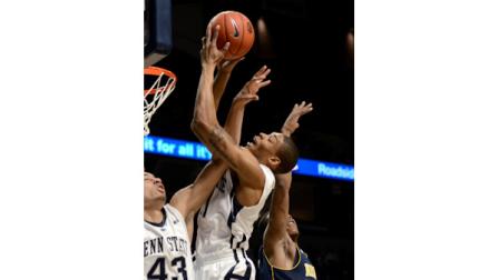 Penn States Jermaine Marshall, center, pulls down a rebound between teammate Ross Travis, left, and a Michigan defender during the first half of an NCAA college basketball game in State College, Pa., Wednesday, Feb. 27, 2013. (AP Photo/Ralph Wilson)